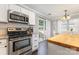 Kitchen area with stainless steel range, subway tile backsplash, and adjacent dining space at 197 Devon Forest Dr, Mooresville, NC 28115