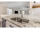Modern kitchen sink with granite countertops and white subway tile at 197 Devon Forest Dr, Mooresville, NC 28115