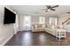 Living room with a comfortable couch, bright windows and access to stairs at 197 Devon Forest Dr, Mooresville, NC 28115