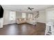 Bright living room featuring hardwood floors and access to staircase and kitchen at 197 Devon Forest Dr, Mooresville, NC 28115