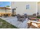 Backyard patio featuring Adirondack chairs, a fire pit, a dining table with chairs, and a grill at 197 Devon Forest Dr, Mooresville, NC 28115