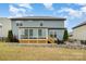 Spacious backyard featuring a screened-in porch, patio, fire pit, and well-maintained lawn at 2014 Drawbridge Dr, Fort Mill, SC 29707