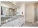 Bright bathroom featuring a double vanity, granite countertops, and a glass-enclosed shower at 2014 Drawbridge Dr, Fort Mill, SC 29707
