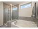 Elegant bathroom featuring a luxurious soaking tub, glass shower, and stylish tile work at 2014 Drawbridge Dr, Fort Mill, SC 29707