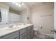 Bright bathroom featuring double sinks, neutral decor, and a large mirror at 2014 Drawbridge Dr, Fort Mill, SC 29707