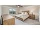 Serene bedroom with neutral colors, a large window, and a classic wooden bed frame at 2014 Drawbridge Dr, Fort Mill, SC 29707