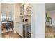 Butler pantry with granite counters, wine rack and drink fridge at 2014 Drawbridge Dr, Fort Mill, SC 29707