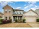 Charming two-story home featuring a brick and siding exterior, landscaped front yard, and attached two-car garage at 2014 Drawbridge Dr, Fort Mill, SC 29707
