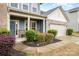 View of the home's front porch and entrance, showing the blue siding, stone accents, and well-maintained landscaping at 2014 Drawbridge Dr, Fort Mill, SC 29707