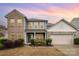 Charming two-story home with a brick and siding exterior, a two-car garage, and manicured landscaping at 2014 Drawbridge Dr, Fort Mill, SC 29707