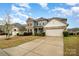 Wide shot of the house, highlighting its architectural details, landscaping, and spacious driveway at 2014 Drawbridge Dr, Fort Mill, SC 29707