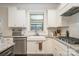 Kitchen featuring granite counters, white cabinets, stainless steel appliances and a farmhouse sink at 2014 Drawbridge Dr, Fort Mill, SC 29707