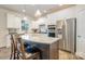 Open concept kitchen with stainless steel appliances, granite counters, white cabinets, and eat-in island at 2014 Drawbridge Dr, Fort Mill, SC 29707