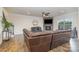 Comfortable living room with a stone fireplace, large sectional sofa, and hardwood floors at 2014 Drawbridge Dr, Fort Mill, SC 29707