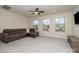 Comfortable living room with plush seating, ceiling fan, and plenty of natural light from large windows at 2014 Drawbridge Dr, Fort Mill, SC 29707