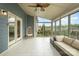 Inviting sunroom showcasing wood-look tile flooring, ample natural light, and cozy seating at 2014 Drawbridge Dr, Fort Mill, SC 29707