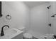 Clean, white bathroom featuring a modern subway tile shower and sleek fixtures at 207 Eden St, Davidson, NC 28036