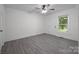 Bright bedroom featuring a ceiling fan, a large window with natural light, and neutral colors at 207 Eden St, Davidson, NC 28036