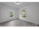Cozy bedroom with two windows offering a view, ample natural light, and neutral colors at 207 Eden St, Davidson, NC 28036