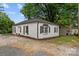 Well-maintained single-story home with brick facade, dark shutters, and manicured landscaping at 207 Eden St, Davidson, NC 28036