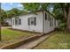 Well-maintained home showcasing brick accents, manicured lawn, and charming walkway at 207 Eden St, Davidson, NC 28036