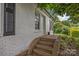 Home entrance featuring brick steps, a white front door, and brick facade at 207 Eden St, Davidson, NC 28036