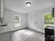 Bright kitchenette with modern vinyl floors and white paint at 207 Eden St, Davidson, NC 28036