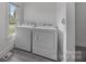 Bright laundry room with modern washer and dryer appliances at 207 Eden St, Davidson, NC 28036