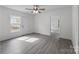 Inviting living room with new vinyl flooring, a ceiling fan, and fresh neutral paint at 207 Eden St, Davidson, NC 28036