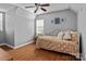 Cozy bedroom with wood-look floors, ceiling fan, and natural light from the window at 20840 Sierra Vista Dr, Cornelius, NC 28031