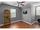 Cozy bedroom with hardwood floors, a ceiling fan, natural light, and TV at 20840 Sierra Vista Dr, Cornelius, NC 28031