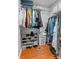 Organized walk-in closet with shelving, hanging rods, and laminate wood flooring at 20840 Sierra Vista Dr, Cornelius, NC 28031