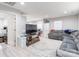 Spacious living room with modern gray sectional, large TV, and bright, neutral decor at 211 E Mcneely Ave, Mooresville, NC 28115