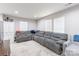 Comfortable living area with a large sectional sofa, soft rug, and natural light from the windows at 211 E Mcneely Ave, Mooresville, NC 28115
