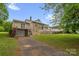 A well-kept backyard with a lush lawn, deck, and easy access to the garage via driveway on one side at 235 Pebble Point Rd, Salisbury, NC 28146