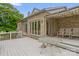 Spacious backyard deck with seating, perfect for entertaining with a view to a large set of windows at 235 Pebble Point Rd, Salisbury, NC 28146