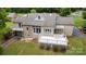 Aerial view of a home's backyard, featuring a spacious deck, multiple balconies and a lush green lawn at 235 Pebble Point Rd, Salisbury, NC 28146