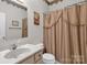 Bathroom featuring a single vanity, toilet, and shower curtain with a decorative border at 235 Pebble Point Rd, Salisbury, NC 28146