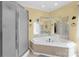 Bathroom showcasing the bathtub with glass shower and decorative mirrors above the tub at 235 Pebble Point Rd, Salisbury, NC 28146