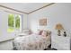 Cozy bedroom with a comfortable bed, window with outdoor view, and decorative floral accents at 235 Pebble Point Rd, Salisbury, NC 28146