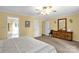 Bright bedroom features an en-suite bathroom, ceiling fan, and light yellow walls at 235 Pebble Point Rd, Salisbury, NC 28146