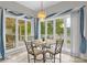 Inviting breakfast nook area with lake views and stylish chandelier lighting at 235 Pebble Point Rd, Salisbury, NC 28146