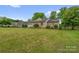 Inviting brick home with lush green lawn, mature trees, and manicured landscaping for a picturesque setting at 235 Pebble Point Rd, Salisbury, NC 28146