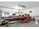 Spacious garage featuring a boat on a trailer, overhead storage, and ample workspace at 235 Pebble Point Rd, Salisbury, NC 28146