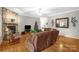 Warm and inviting living room with a stone fireplace, comfortable seating, and hardwood floors at 235 Pebble Point Rd, Salisbury, NC 28146