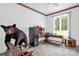 Bright home office with an L-shaped desk, large window, and a unique black bear statue at 235 Pebble Point Rd, Salisbury, NC 28146