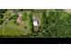 Aerial view of the property showcasing a large lot, house, and metal garage surrounded by lush trees at 2500 Cedar Cove Dr, Harrisburg, NC 28075