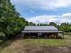 Large open barn featuring ample storage space and equipment, surrounded by green trees and lawn at 2500 Cedar Cove Dr, Harrisburg, NC 28075