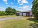 Large barn featuring two garage doors and ample space, situated on a sprawling green lawn at 2500 Cedar Cove Dr, Harrisburg, NC 28075