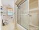 Bathroom featuring a shower with sliding doors, vintage wallpaper and tile flooring at 2500 Cedar Cove Dr, Harrisburg, NC 28075